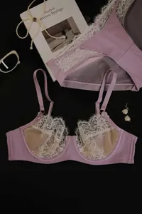 Detailed flat lay of lavender lace lingerie set with eyelash lace and accessories