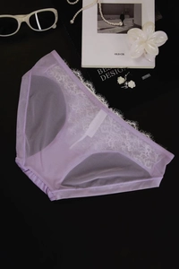 Detailed view of light purple lace panties with floral embroidery and mesh texture