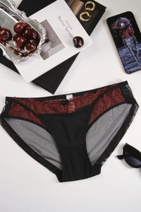 Flat lay of black mesh lace panties with red floral embroidery and bow detail