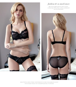 Detail of black lace lingerie set with bow accents and sheer mesh stockings
