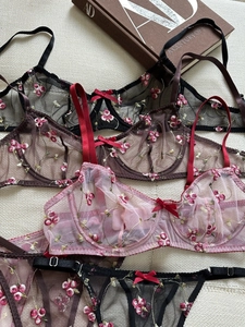 Close-up of floral embroidery on sheer mesh lingerie sets in various elegant colors