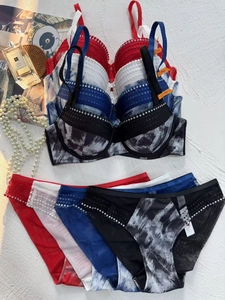 Lace lingerie set detail with rhinestones and ink print patterns including 75C size tag