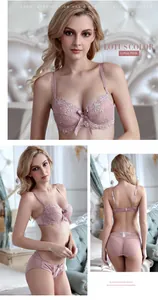 Detail of Lotus Pink lace lingerie set showing floral embroidery and ribbon bow on bra