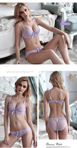 Detail view of purple sheer lace lingerie set with floral embroidery and satin bows
