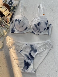 Detailed view of ink print lingerie set with rhinestone trim and lace panels