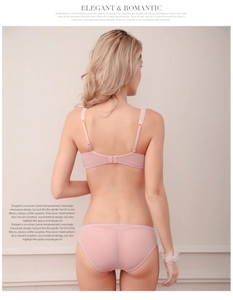 Detail of the sheer pink lace bra with thin straps and delicate back hook closure