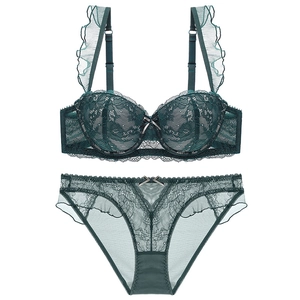 Detail of dark green lace lingerie set with ruffled straps and floral embroidery