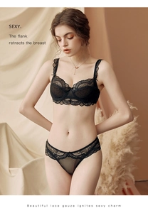 Detail of sheer black lace lingerie set with floral embroidery and bow accents