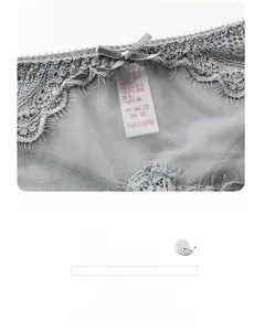 Detail of grey floral lace panties featuring a satin bow and breathable mesh texture