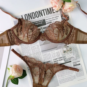 Detail view of coffee brown lace lingerie set with floral embroidery and mesh texture