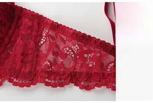 Close-up of red lace bra side wings showing breathable hollow floral patterns