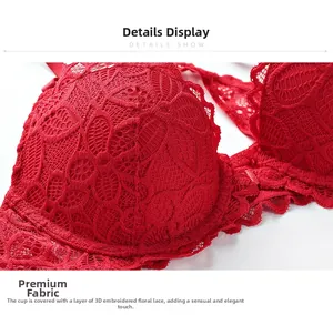 Detailed macro view of red lace bra with intricate floral embroidery and scalloped edges