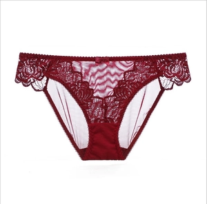 Close-up of wine red lace underwear with floral patterns and a small satin bow detail