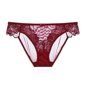 Elegant wine red lace panties with floral embroidery and bow detail on a white background