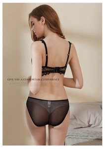 Detail of black lace bra with dual-row hook closure and back floral embroidery