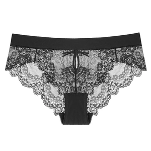 Detail of black lace panties with a delicate bow and scalloped floral edges