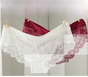Detail showing delicate white and burgundy lace panties with scalloped eyelash edges