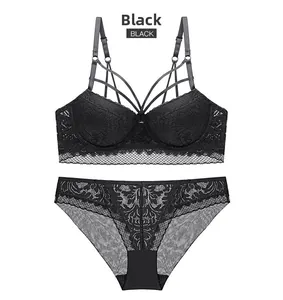 Detail of black floral lace lingerie set with strappy design and scalloped edges