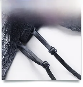 Detail view of adjustable thin elastic shoulder straps on black floral lace bra