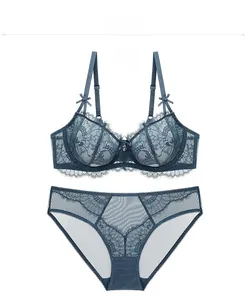 Detailed view of light blue lace bra set with floral patterns and bow decoration