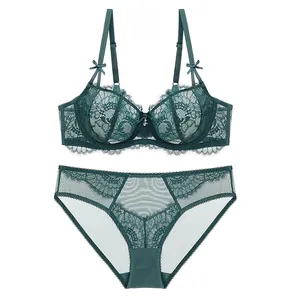 Detail of dark green floral lace lingerie set showing bra bows and eyelash lace trim