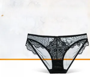 Close-up of black floral lace underwear with sheer mesh and a delicate bow detail