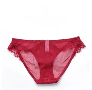 Detail of red sheer lace underwear showing delicate mesh and scalloped eyelash trim
