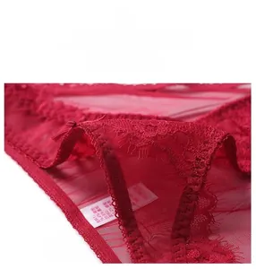 Close-up of red floral lace detailing and small bow on the elastic waistband