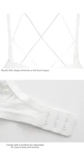 Detail of white lace bra featuring elastic cross straps and three-row back hook closure