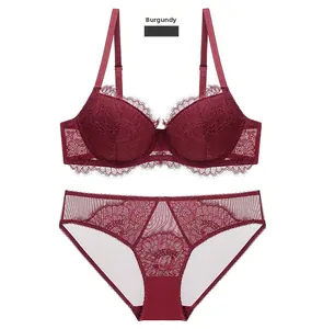 Detail of wine red lace lingerie set featuring eyelash lace trim and sheer mesh fabric