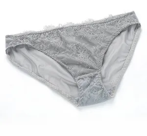 Close-up detail of grey eyelash lace and breathable mesh fabric on sexy lingerie briefs