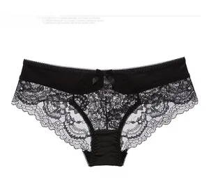 Close-up of black lace floral pattern and satin bow detail on women's sheer panties