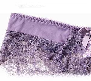 Close-up of purple floral lace panties featuring a delicate satin bow at the elastic waistband