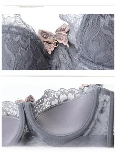 Detail of grey lace bra featuring a soft bow and golden metal pendant decoration