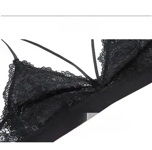 Detailed view of black lace triangle bra featuring delicate eyelash trim and multi-strap design