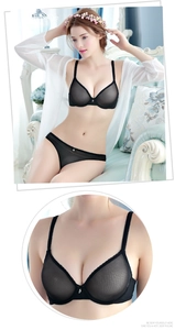 Detail of sheer black mesh lingerie set with delicate pendant and thin shoulder straps