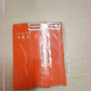 Close-up of matte transparent bra straps with white plastic hooks in card packaging