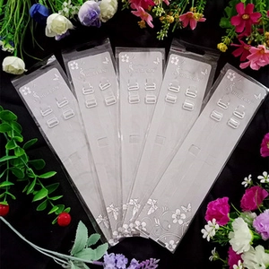 Detailed view of clear TPU bra straps set on elegant floral black background