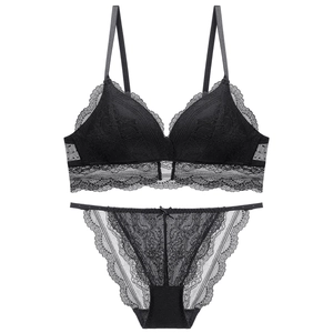 Detailed close-up of black lace triangle bralette and matching sheer mesh panties set
