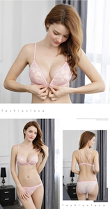 Detailed close-up of light pink lace triangle bralette with front closure and floral embroidery