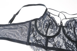 Detailed view of black lace bra with floral patterns and adjustable thin straps