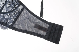 Close-up of deep blue lace bra showing three-row hook closure and mesh side wings