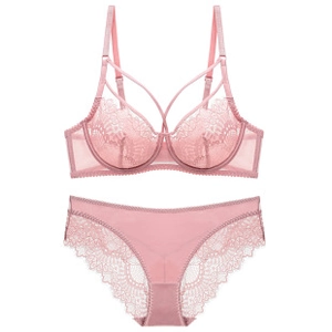 Detailed close-up of pink lace lingerie set with floral patterns and cross straps