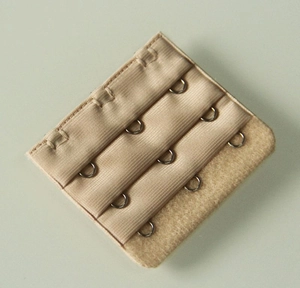 Detail of nude 3-row 3-hook bra extender showing soft fabric texture and metal hooks