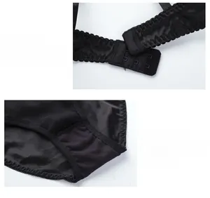 Detail view of black satin bra back closure and matching breathable cotton crotch
