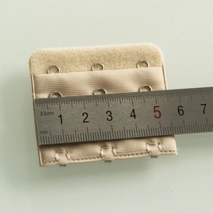 Beige 3-row bra extender made of elastic fabric with hooks, 5.8cm width shown with ruler