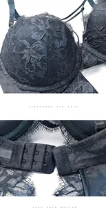 Detail view of navy blue lace bodysuit showing floral embroidery and back hook closure