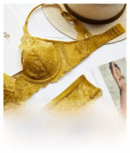 Flat lay of mustard yellow eyelash lace lingerie set with underwire bra and mesh panties