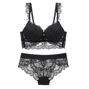 Elegant black lace lingerie set with push-up bra and matching panties on white background