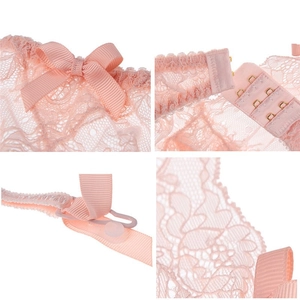 Lace garter belt for women in light pink featuring bow accents and metallic hooks